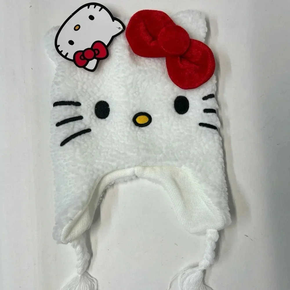 White hello Kitty hat, Sherpa outside red bow, braided tassels on the side